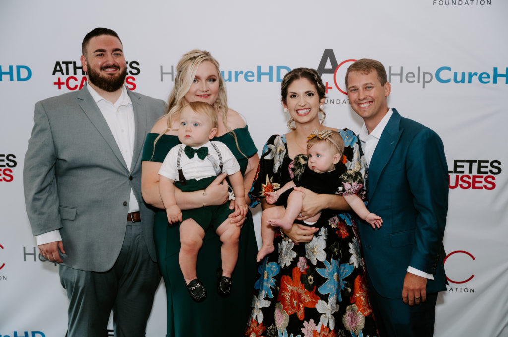 Christian & Megan Pratt with baby Lincoln, Morgan & Matthew Gothard with baby Addie Ruth at the HelpCureHD fundraiser at Minute Maid Park. (Photo by Tay Photography)
