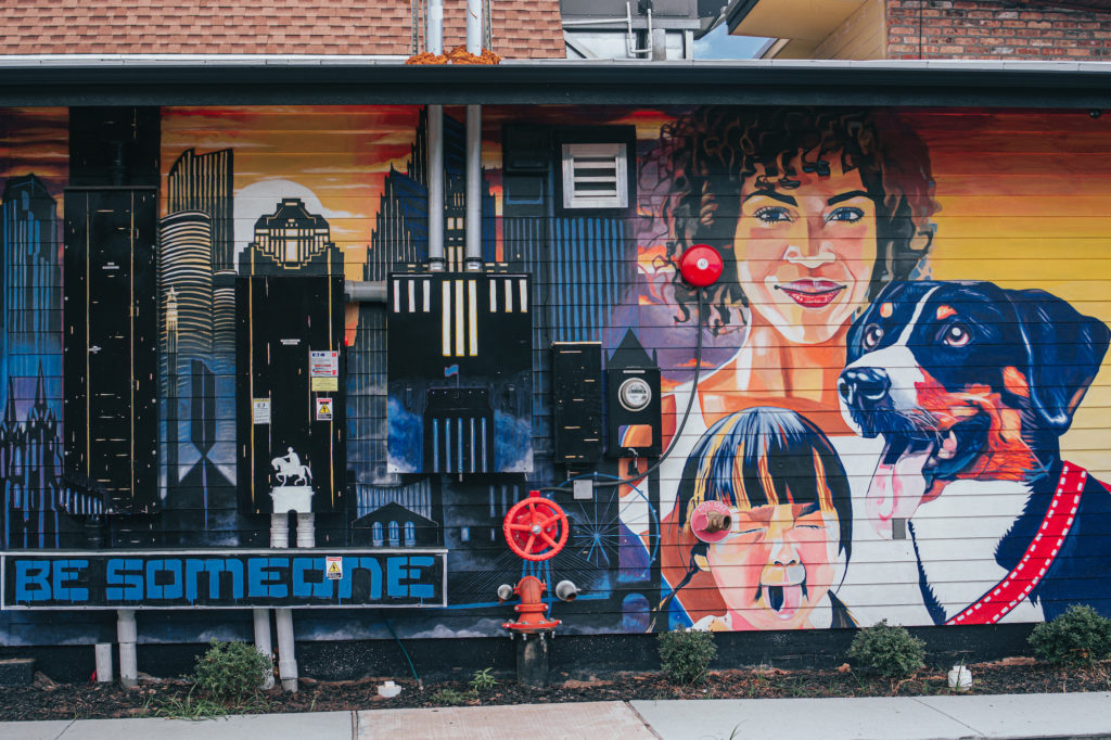 The murals created by local artists outside Rosland are as colorful as those inside. Here a pup from Straydog.org is depicted, a non-profit beloved by Rosland and its owners. (Photo by Raydon Creative)