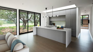 Dario – Driftwood Villas modern kitchen design with skylights and waterfall countertops.
