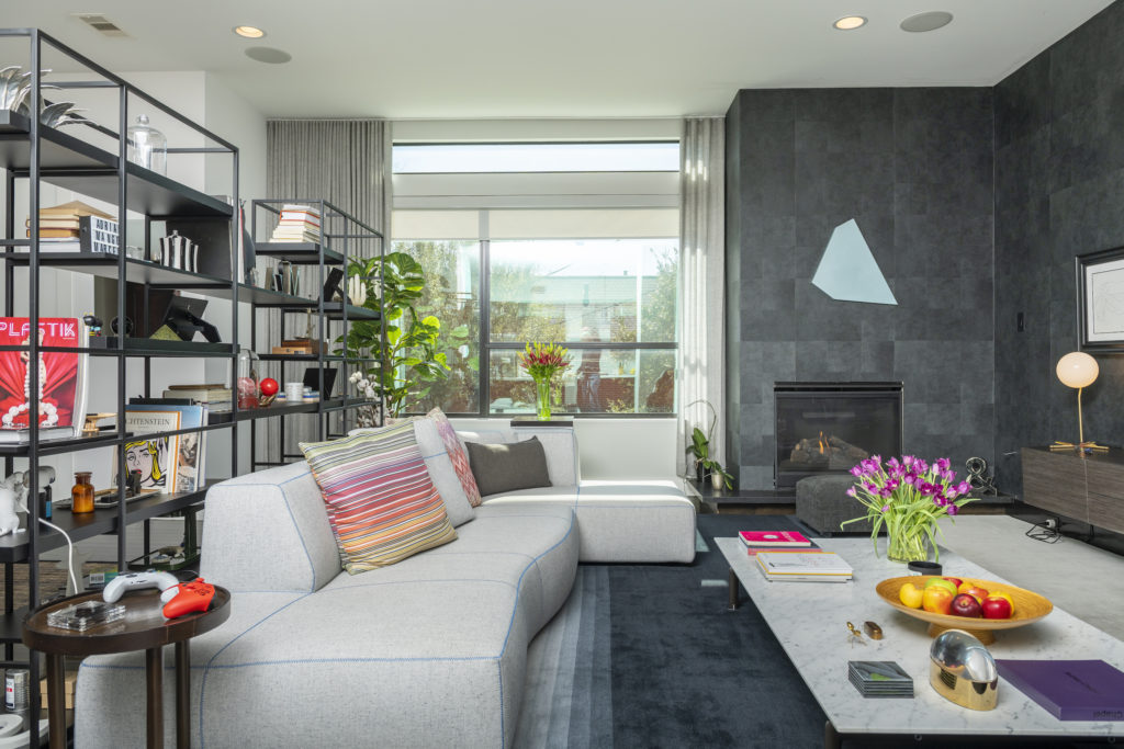 Owners of 1922 Fairview covered walls of the living room in striking charcoal gray paper setting off the art collection. (Photo by Anthony Rathbun)