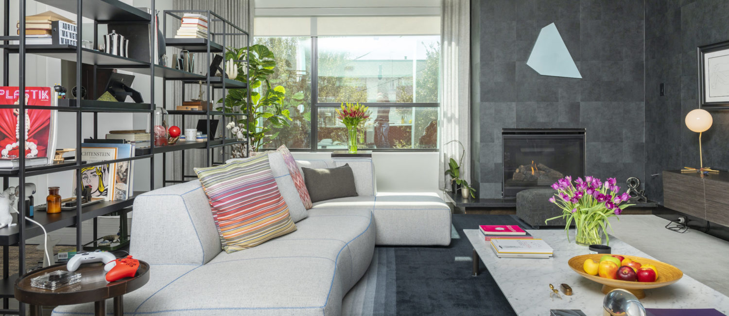 Owners of 1922 Fairview covered walls of the living room in striking charcoal gray paper setting off the art collection. (Photo by Anthony Rathbun)