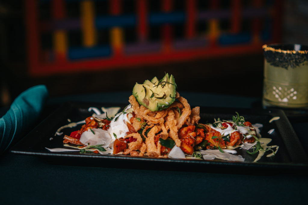 Rosland's Firecracker Shrimp app is made with chile butter glazed spicy blackened shrimp with crispy sweet onions, leeks, chives, and Mexican crema, $19.  (Photo by Raydon Creative)