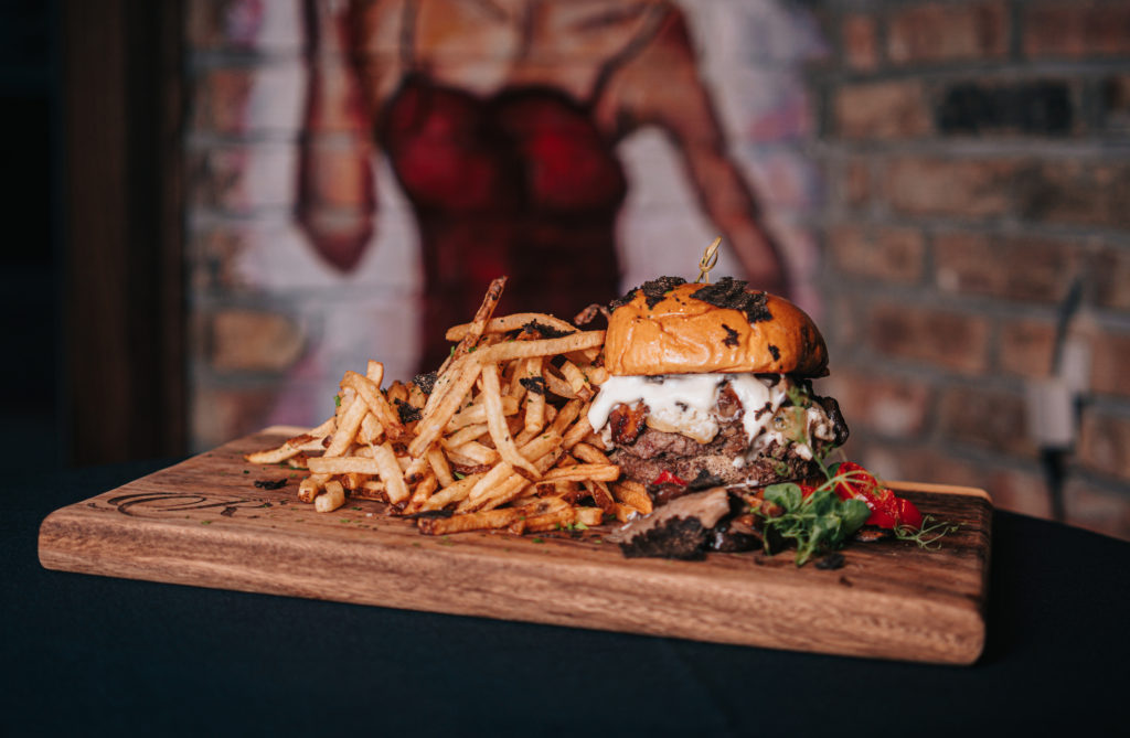Rosland's Legacy Burger is a decadent treat made with dry aged house-ground sirloin beef with wild mushrooms and a foie gras butter. (Photo by Raydon Creative)