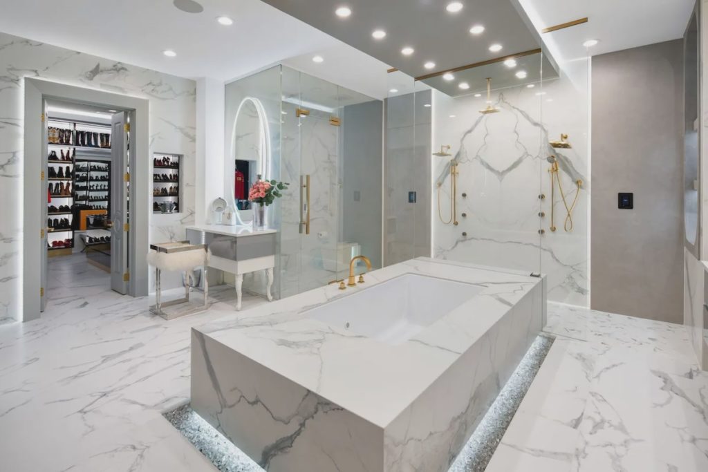 Fire glass surrounds the master bathroom's freestanding tub.
