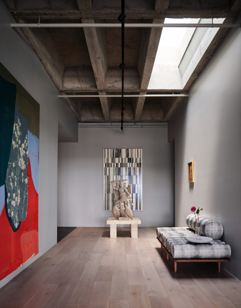 In a side gallery, is a red-and-blue painting by Lauren Luloff from Barbara Davis Gallery. Tacchini bench in Kravet fabric from Casa Houston. (Photo by Pär Bengtsson)