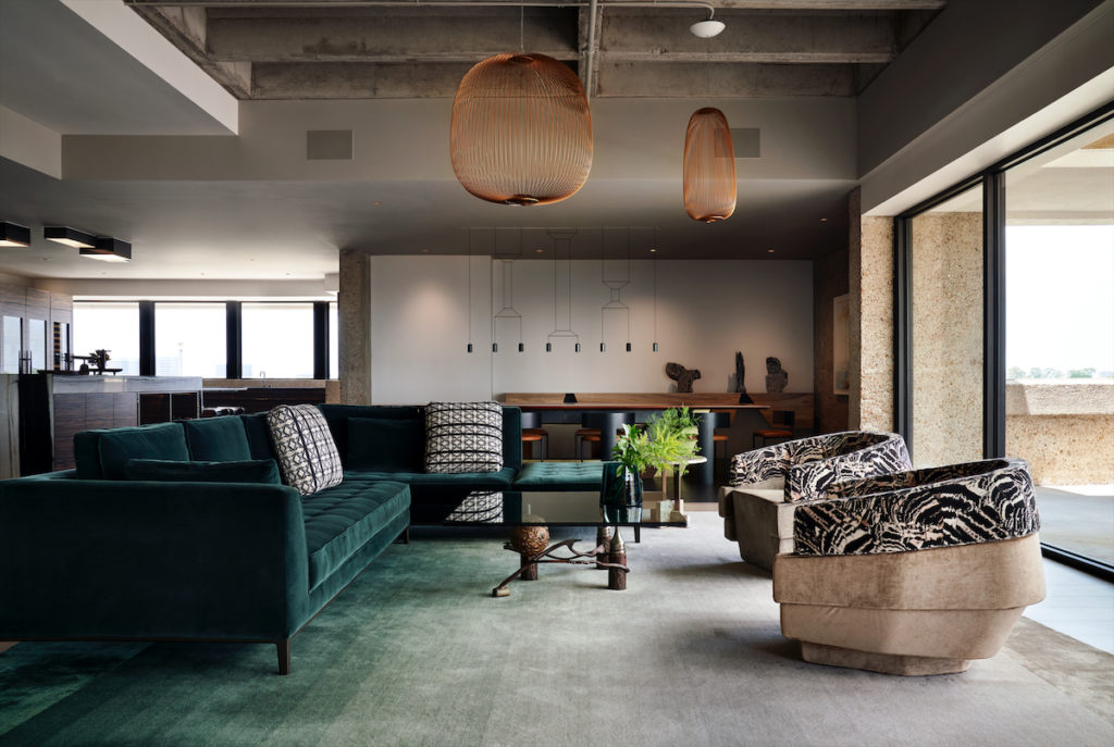 A seating area in the living room, with B&B Italia sectional from BeDesign, Houston. Custom Moroso chairs and CC-Tapis rug from Shop, Houston. Foscarini pendants. Coffee table from clients’ own collection. Vibia pendants in background.  (Photo by Pär Bengtsson)
