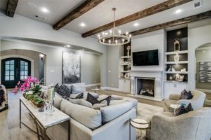 6025 Lakeside – enjoys a neutral palette grounded by warm hardwoods and rustic beams overhead.