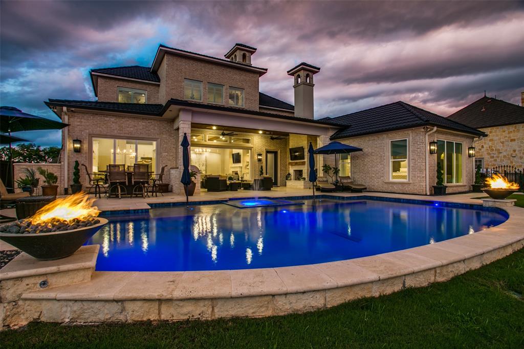 Outdoors is an oasis at 6025 Lakeside Drive, with a dramatic pool, fire urns and a water feature.