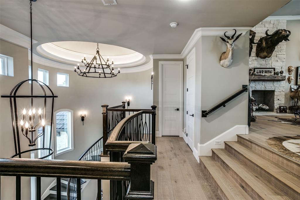 Dramatic wrought iron lighting leads you up the spiral staircase to the exotic den.