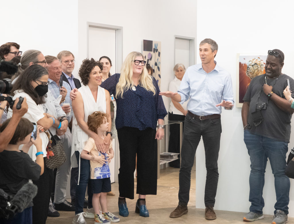 Beto O'Rourke speaking to crowd with the fundraiser's chairs Erin Cluley and Dina Light-McNeely (Photography by Exploredinary)