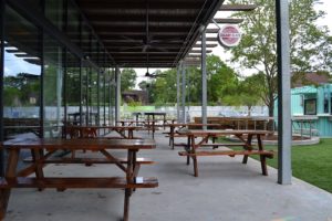 Cherry Block Smokehouse patio opens up to the greenspace at Stomping Grounds.