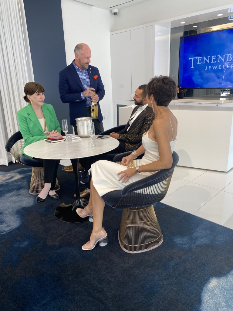 Tenenbaum Jewelers owner Tony Bradfield pops the cork on the Cristal for Shelby Hodge, Fady Armanious and Dominique Sachse
