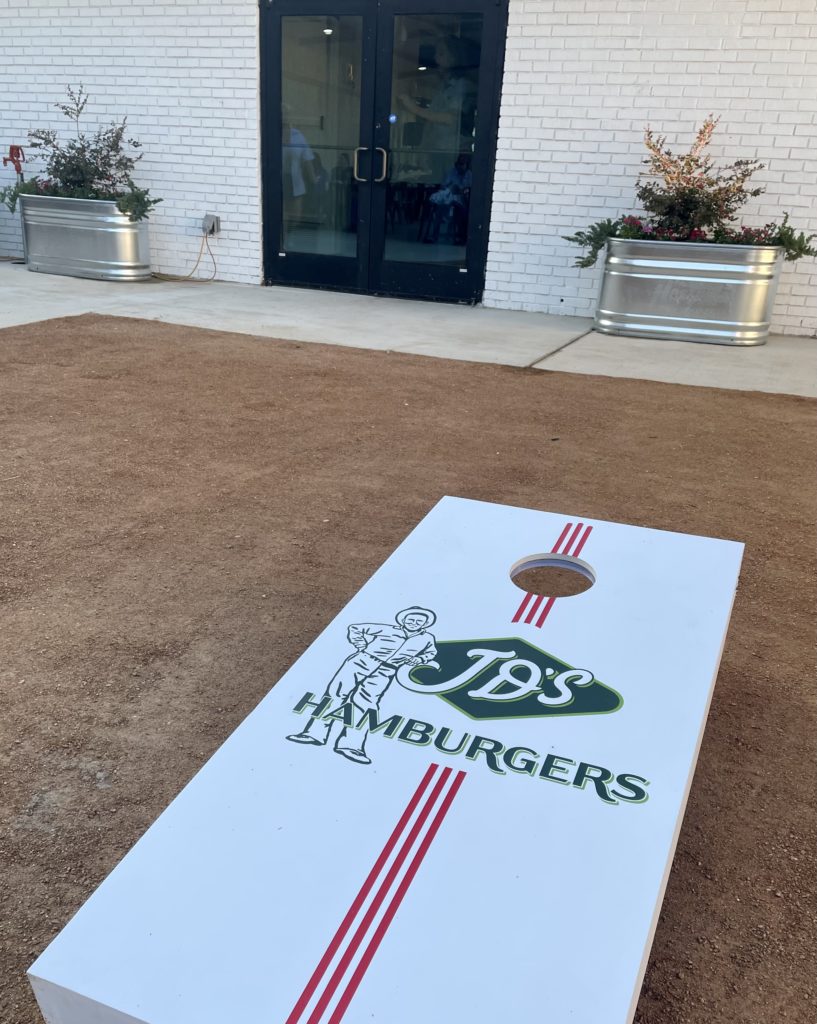 Cornhole on the patio next to the shipping container kitchen. Photo by Courtney Dabney. 