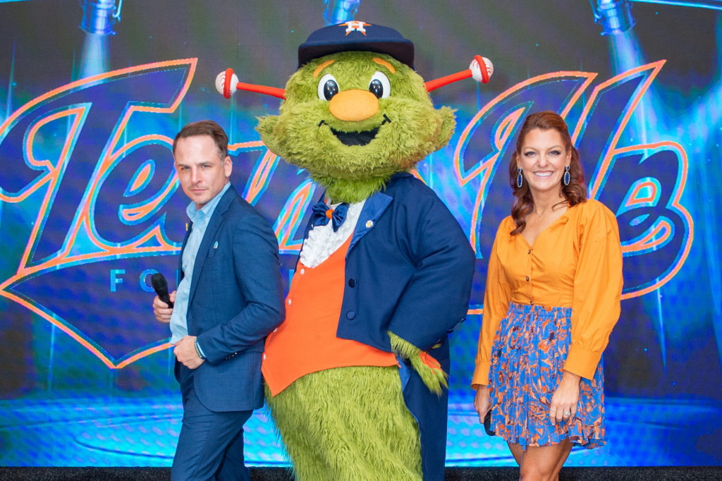 Auctioneer Johnny Holloway, Orbit & the Astros' Julia Morales at the Houston Astros Team Up event at Tootsies (Photo by Jacob Power)