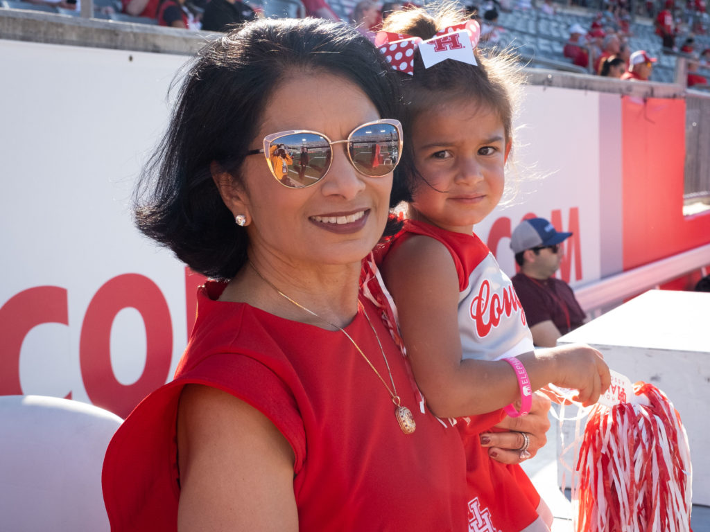 UH president Renu Khator brought a young Cougar to enjoy the game. (Photo by F. Carter Smith)