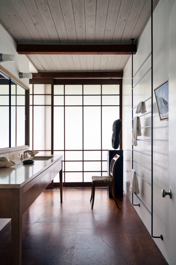 A Shoji screen in the main bathroom provides access to a greenhouse. Biedermeier chair. Donald Vogel designed the welded steel towel bar. David Dreyer painting. Photo by Pär Bengtsson / art direction by Michelle Aviña)