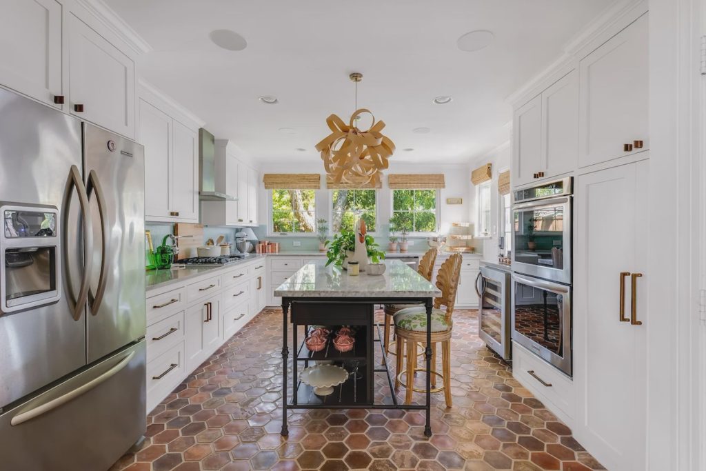 The remodeled kitchen features birchwood pendant lights. 