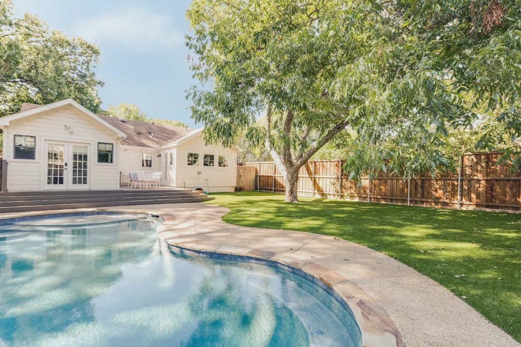 A resort-style pool and low maintenance turf in the backyard.