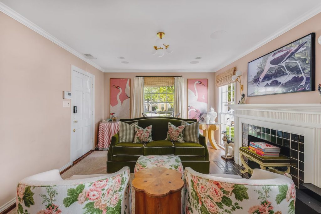 A duo of framed heron Gucci wallpaper frames the living area windows.  