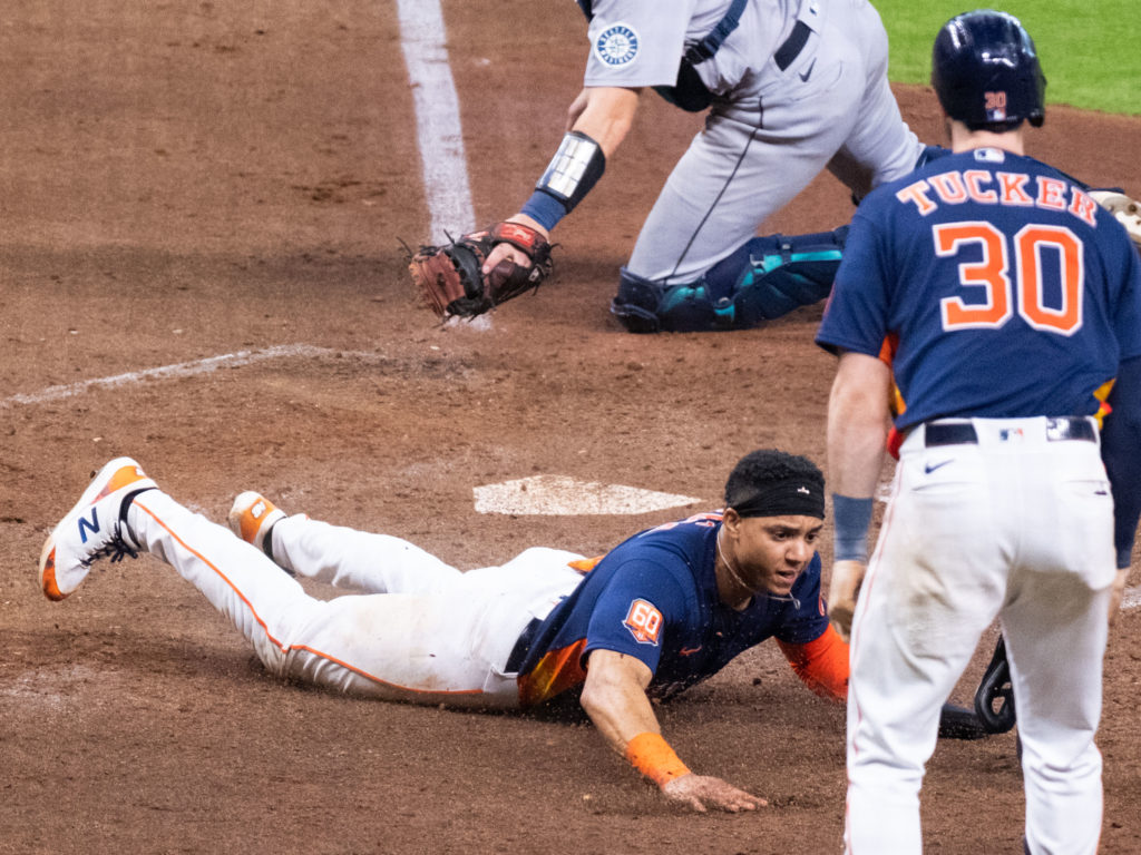 Jeremy Pena certainly gave it his all on the slide across home. (Photo by F. Carter Smith)