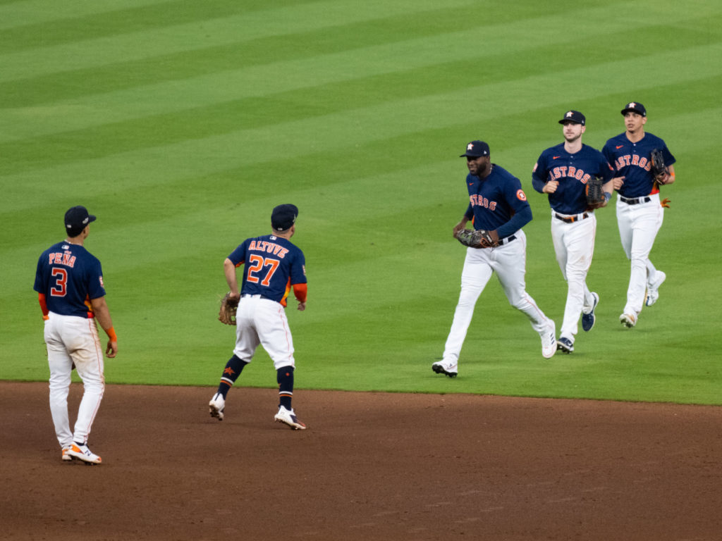 The Houston Astros are used to celebrating after big playoff wins. And Jose Altuve couldn't wait to greet Yordan Alvarez. Photo by F. Carter Smith)