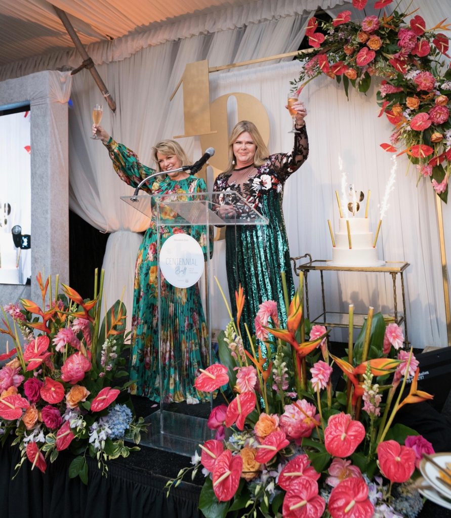 Houston Zoo Centennial gala chairs Kelley Lubanko and Kelli Weinzierl make a champagne toast as part of the celebration. (Photo by Daniel Ortiz)