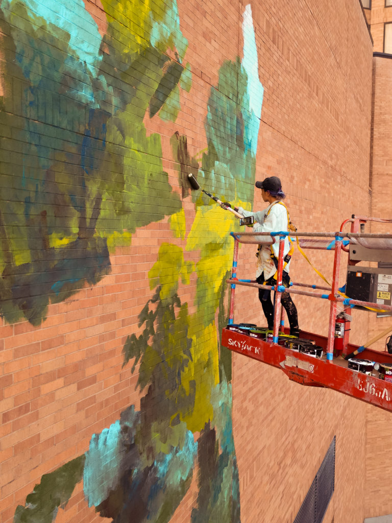 Emily Ding paints "Loving Houston." (Photo by @superkant and @cyvisuals_, courtesy Street Art for Mankind)