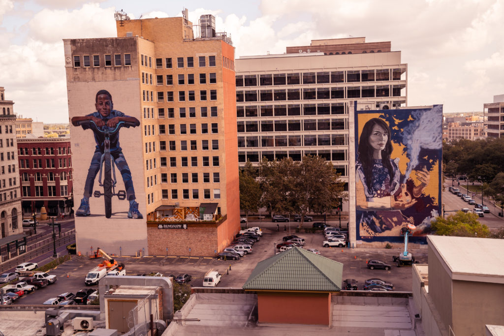Houston Downtown murals "Social Equity" and "La Shamana" stand across the street from each other. (Photo by @superkant and @cyvisuals_, courtesy Street Art for Mankind)