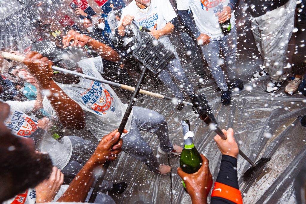 The Astros danced with brooms in a champagne-soaked clubhouse after sweeping the New York Yankees right out of the playoffs. (@Astros)