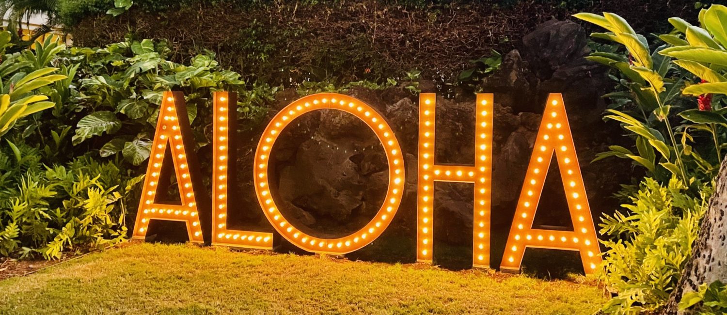 HIFW – The classic Hawaiian greeting at the entrance to the Hawii Food and Wine Festival’s launch event on the island of Maui. Photo by Courtney Dabney.