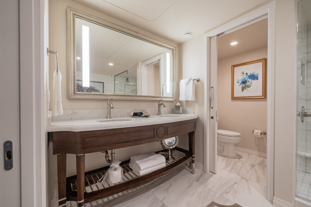 The bathrooms were all renovated throughout the hotel. Here, the new suite's light filled baths are topped with marble double vanities, walk-in showers with soaker shower heads and lit mirrors. (Photo by Courtesy of The Houstonian Hotel, Club and Spa)