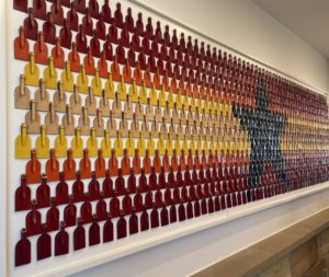 LV – Artwork featuring Louis Vuitton’s classic luggage tags. Photo by Courtney Dabney.