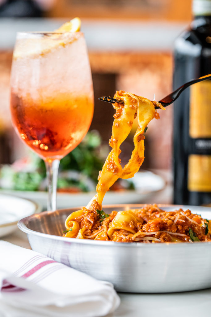 An Aperol spritz accompanies a pappardelle alla Bolognese at Numero28 Houston. (Photo by Becca Wright)