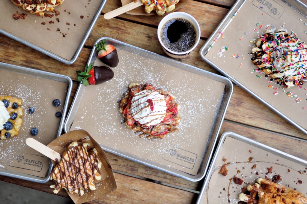The Press Waffle Company at Lyric Market specializes in creating authentic Belgium waffles, both savory and sweet varieties.
