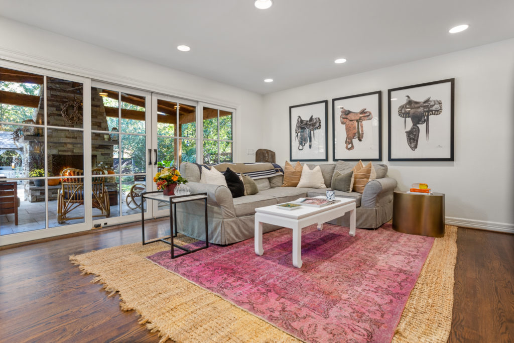 Den with warm oak under foot and a 12 foot sliding doors leading the to the covered patio.