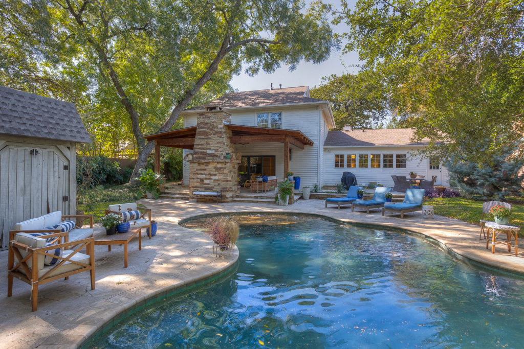 The pool and limestone surround with several seating areas are perfect for family and friends.