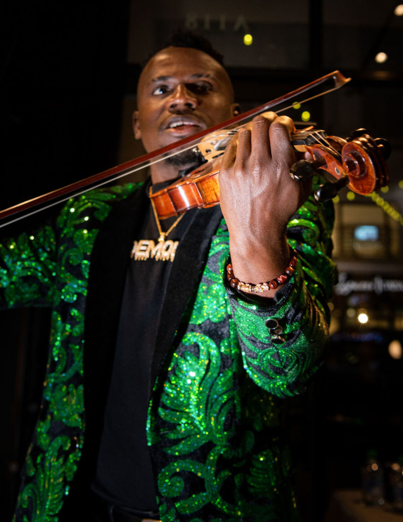Violinist Demola performed at CAM Studio Poliform Grand Opening. (Photo by Shane Dante)