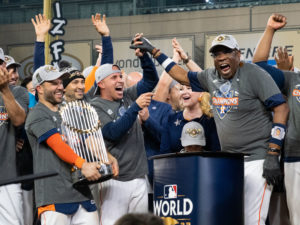 ose Altuve could only smile at how happy manager Dusty Baker was. And continue to hug that trophy. (Photo by F. Carter Smith)