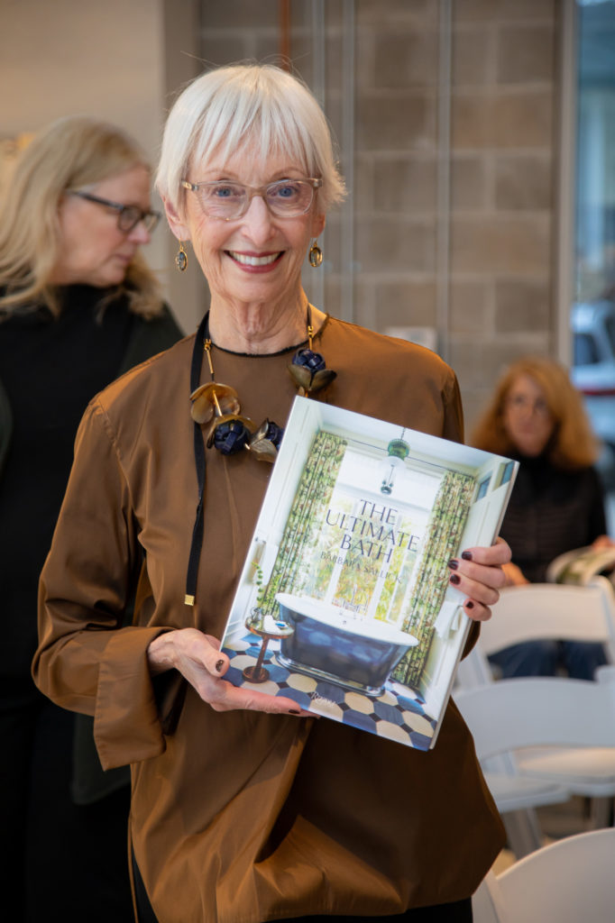 Barbara Sallick holds her fifth book, "The Ultimate Bath" at her book signing at Elegant Additions. (Photo by Miroma Photography)