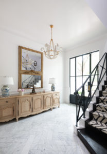Bowen – The home’s foyer was already grand, Wilson accentuated the moldings in white lacquer. Photo by Michael Hunter
