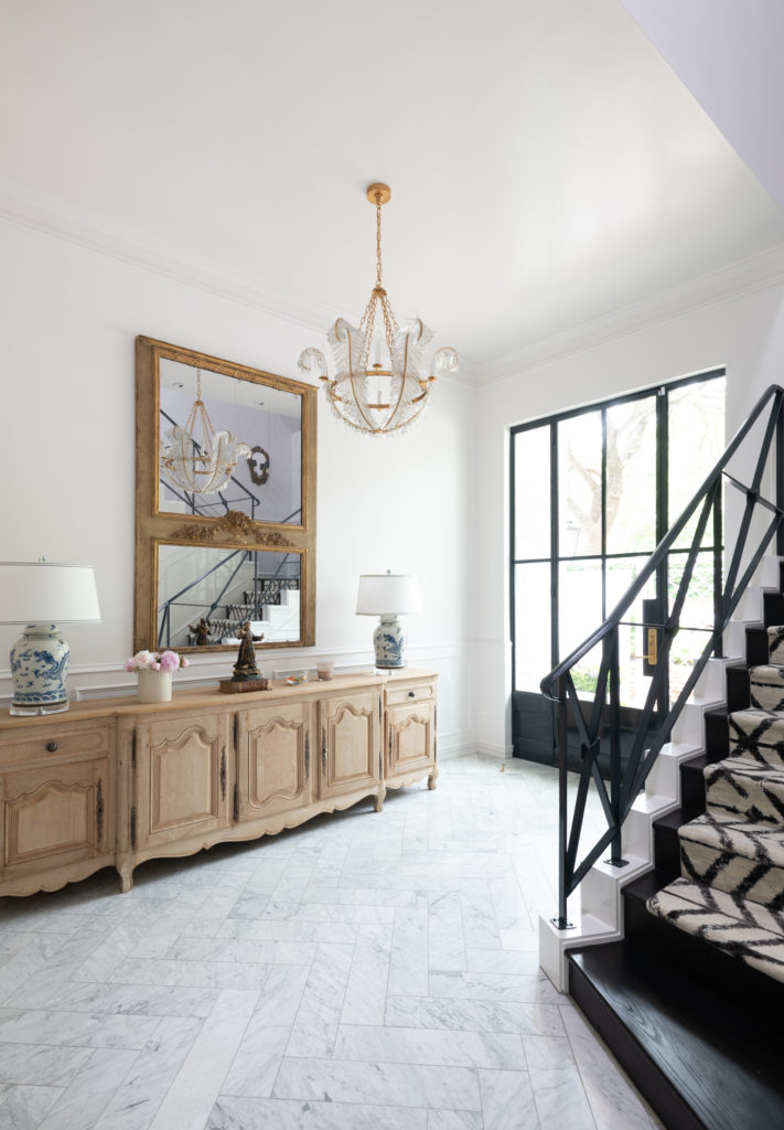 The home's foyer was already grand, Wilson accentuated the moldings in white lacquer. Photo by Michael Hunter.