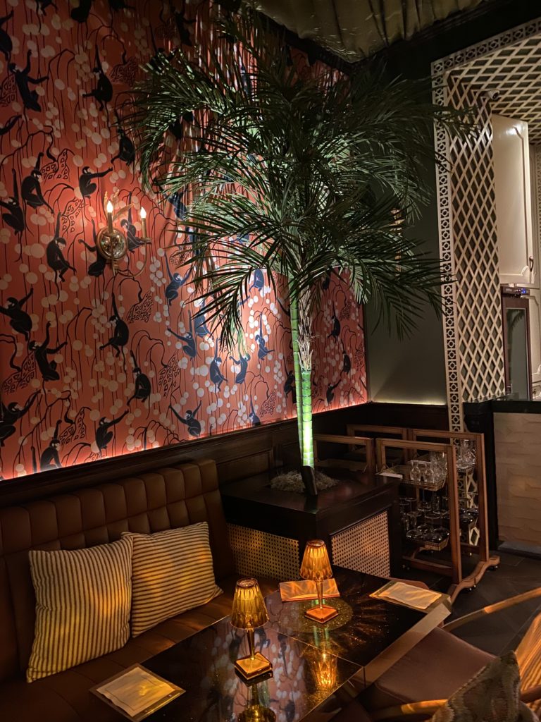 Monkeys traipse across the wallpaper at Emilia's Havana, a chic speakeasy entered through The Annie Café kitchen. (Photo by Shelby Hodge)