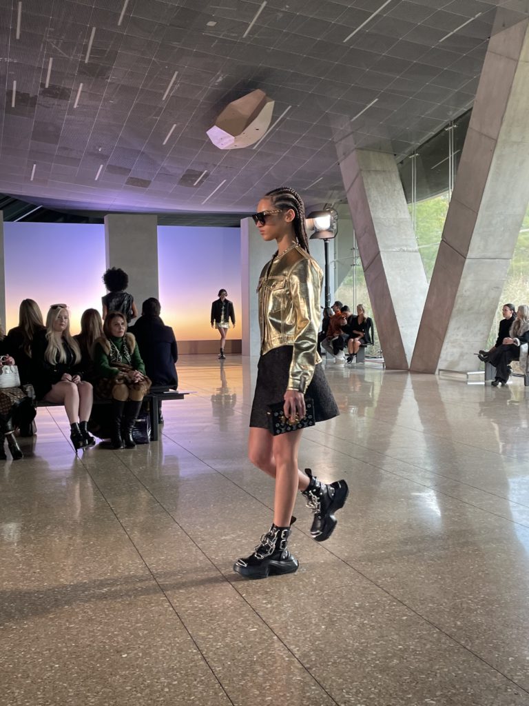 Gilded gold jacket pairs with A-line skirt and boots with chain link embellishment. Photo by Courtney Dabney.