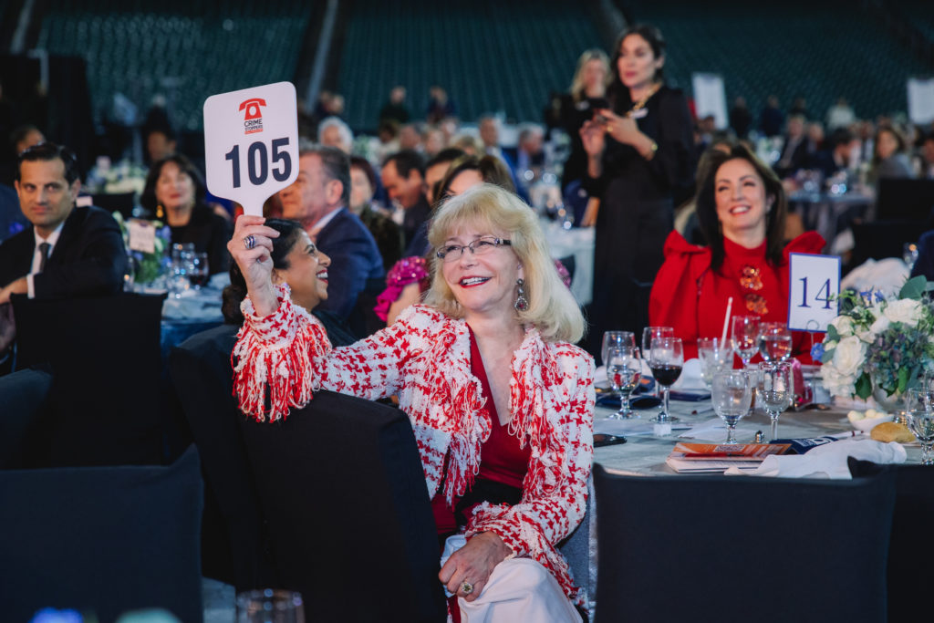 Susan Boggio bids in the 'Last Paddle Standing' vying for one of two Zadok Jewelers gift certificates. (Photo by CatchlightGroup.com)