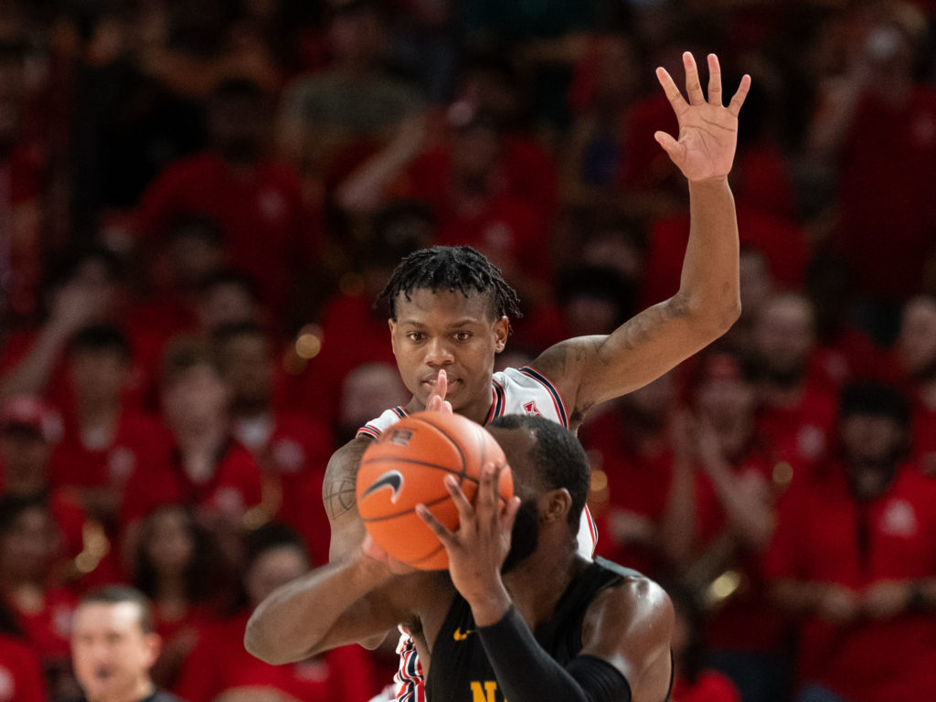 Sometimes it seems like UH and Marcus Sasser loom over opponents. (Photo by F. Carter Smith)
