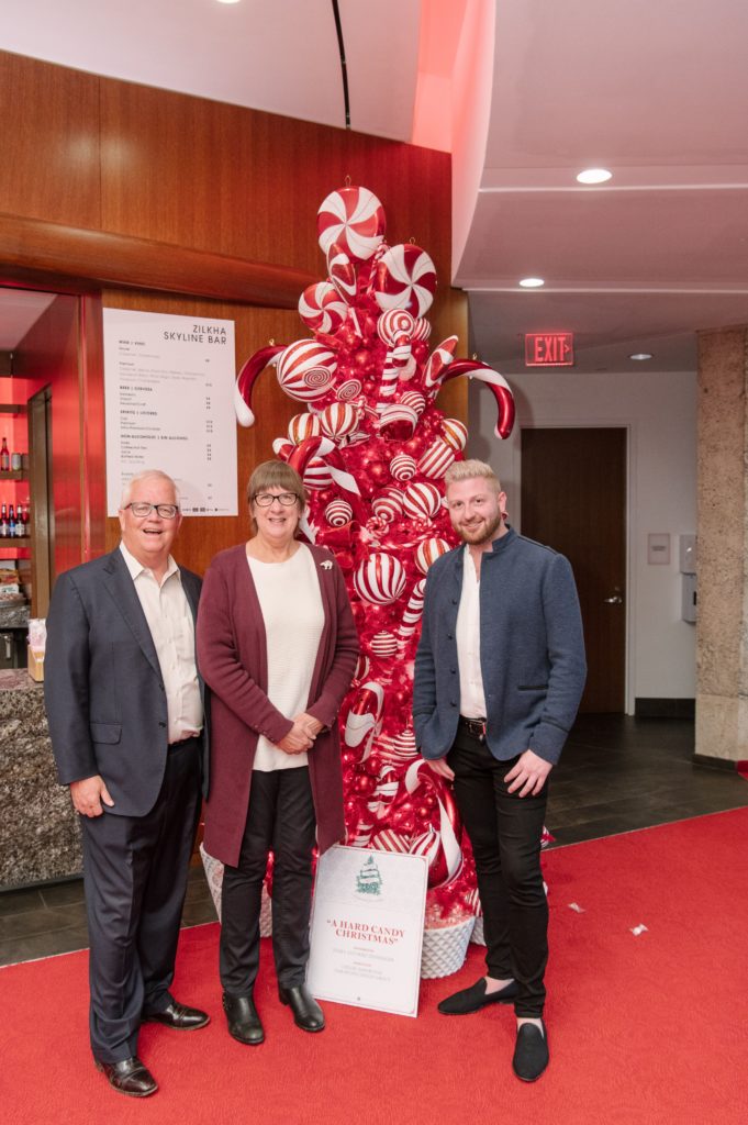 Debra & Mike Dishberger with Taylor DeMartino with one of two trees designed by DeMartino Design for the Alley Theatre's Deck the Trees fundraiser. (Photo by Thomas Campbell)