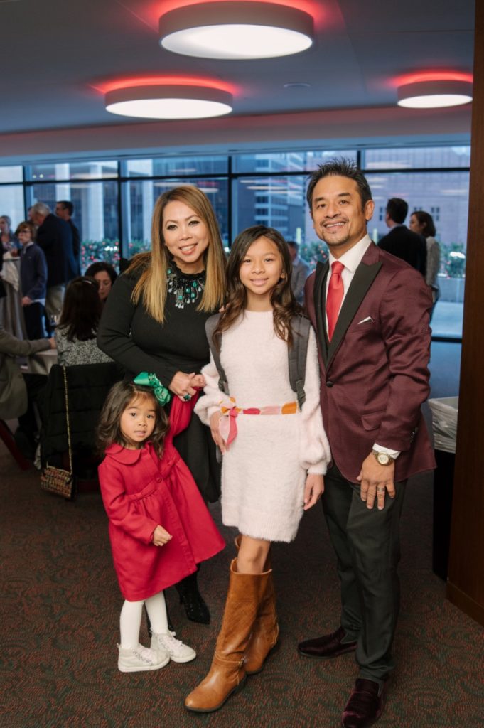 Tree designer Thanh Le, of the Vietnamese Science and Culture Association, with her family at the Deck The Trees reception (Photo by Thomas Campbell)
