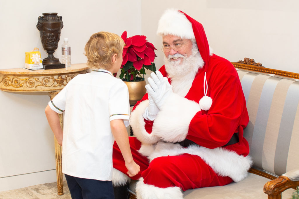 Santa and a hopeful Artemis Perleberg at Valobra Master Jewelers holiday party.
