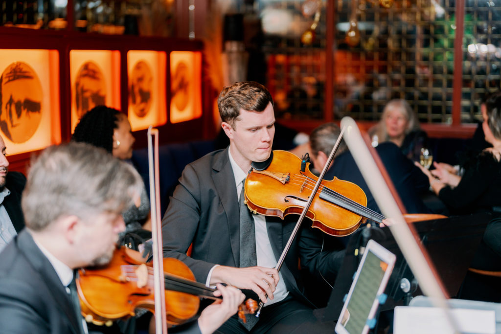 DIVISI Strings performing at the Nan and Company Properties holiday bash at MAD.  (Photo by Jared Hernandez, Nan Studios)
