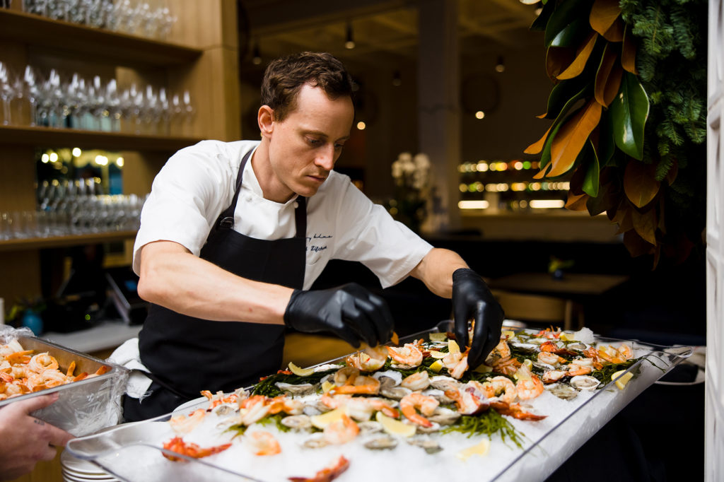 Jerrod Zifchak arranging the raw bar at the Texas Children's Hospital Ambassadors Holiday Party held at Navy Blue in Rice Village (Photo by Jenny Antill Photography)